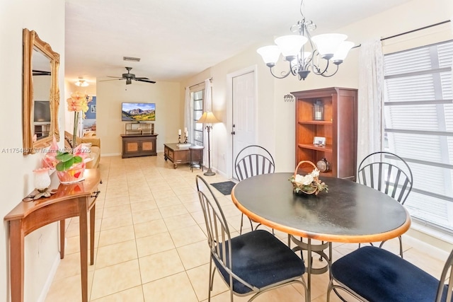 dining area featuring ceiling fan with notable chandelier, visible vents, baseboards, and light tile patterned floors