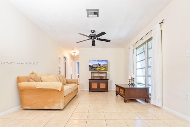 living area with visible vents, baseboards, and light tile patterned flooring