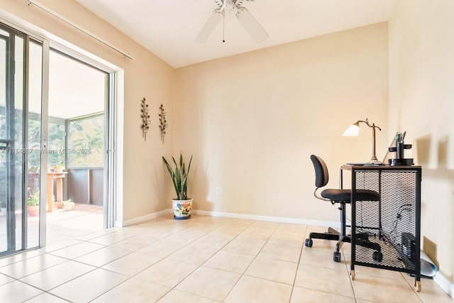 exercise area featuring tile patterned flooring, baseboards, and a ceiling fan