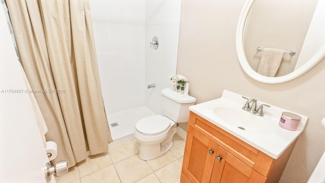 bathroom featuring a stall shower, tile patterned flooring, vanity, and toilet