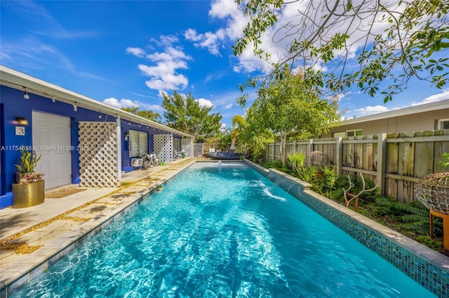 view of pool featuring a patio area, a fenced backyard, and a fenced in pool