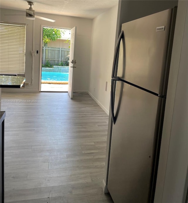2217 NE 14th Ave, Wilton Manors, FL 33305 - kitchen featuring a ceiling fan, freestanding refrigerator, baseboards, and wood finished floors
