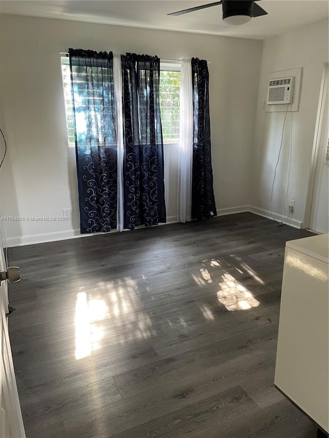 2217 NE 14th Ave, Wilton Manors, FL 33305 - spare room featuring ceiling fan, baseboards, dark wood-type flooring, and an AC wall unit