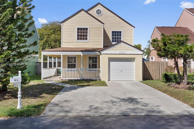 view of front facade with a garage, concrete driveway, a porch, and fence