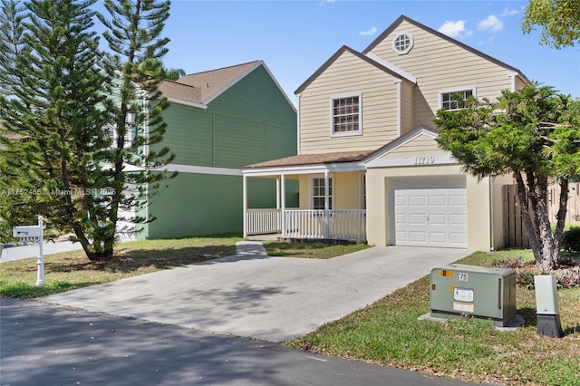 traditional-style house featuring covered porch, an attached garage, and concrete driveway