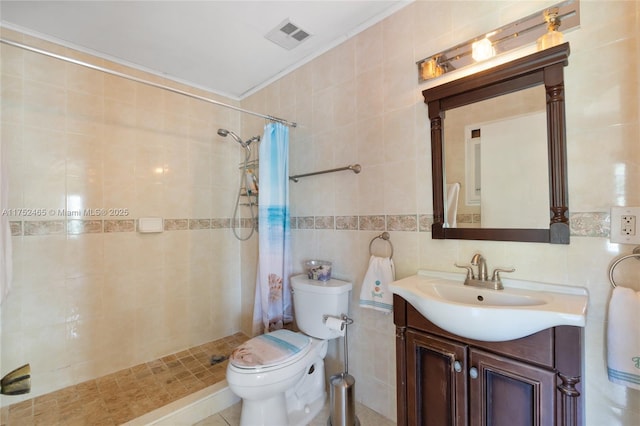 full bath featuring visible vents, vanity, tile walls, a stall shower, and crown molding