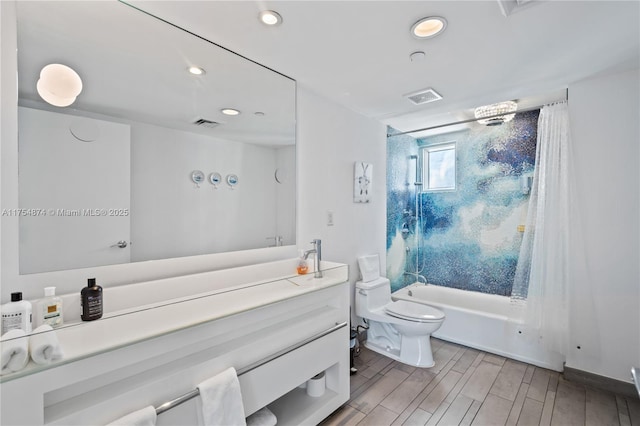 bathroom with shower / bath combination, visible vents, toilet, wood tiled floor, and vanity