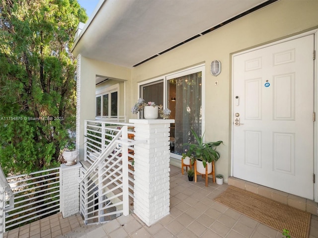 entrance to property featuring stucco siding