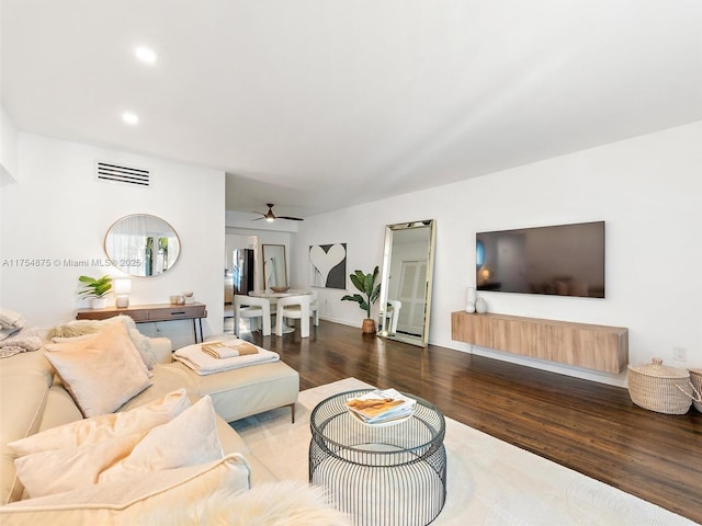 living room featuring ceiling fan, wood finished floors, visible vents, and recessed lighting