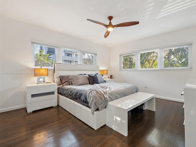 bedroom with ceiling fan, baseboards, and dark wood-type flooring