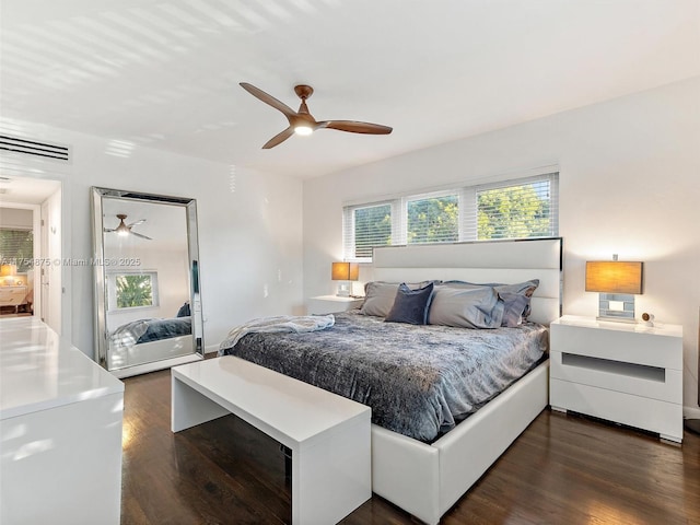 bedroom featuring dark wood-type flooring, visible vents, and a ceiling fan