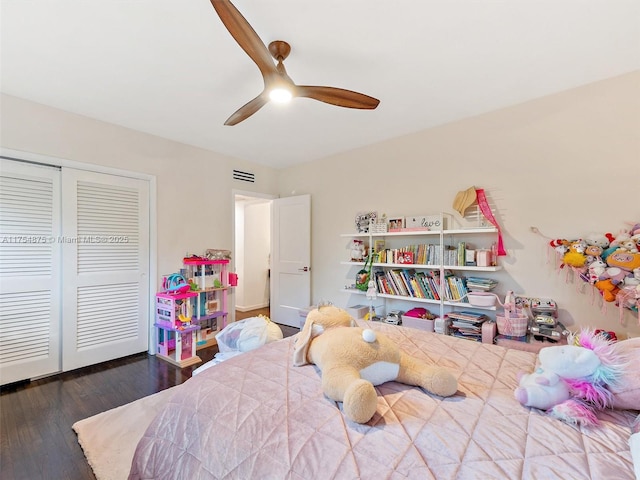 bedroom featuring a ceiling fan, a closet, visible vents, and wood finished floors