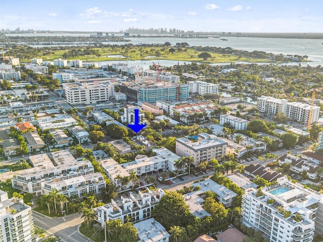 birds eye view of property with a view of city and a water view