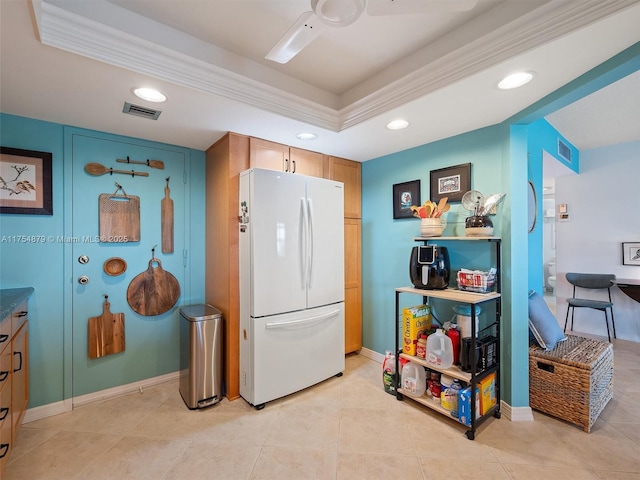 kitchen with recessed lighting, visible vents, a raised ceiling, and freestanding refrigerator