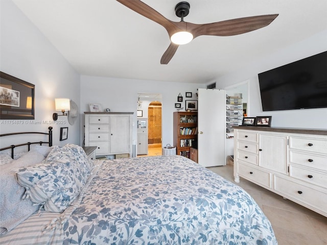 bedroom with a ceiling fan, arched walkways, ensuite bathroom, and tile patterned floors