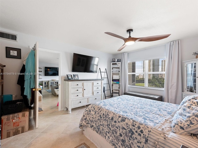 bedroom featuring visible vents, light tile patterned flooring, and a ceiling fan