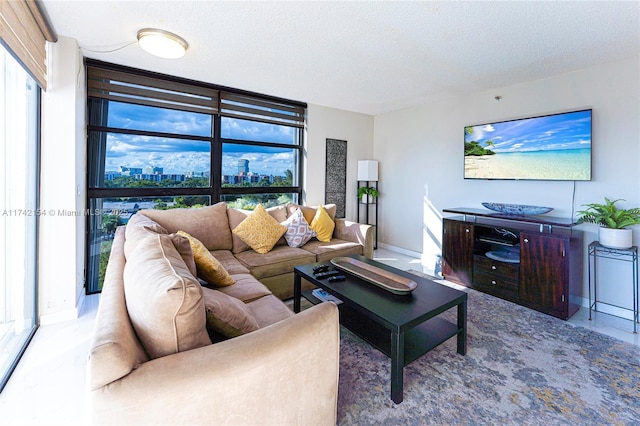 living room with a wall of windows, a textured ceiling, and baseboards