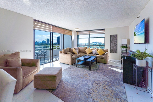 living room featuring a healthy amount of sunlight, a textured ceiling, and expansive windows