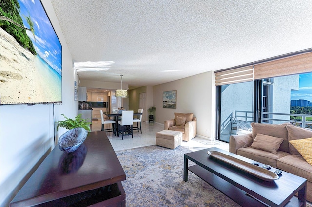 living area featuring floor to ceiling windows, baseboards, light speckled floor, and a textured ceiling