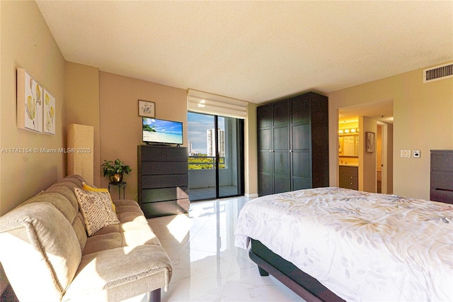 bedroom featuring marble finish floor, access to exterior, visible vents, and a textured ceiling