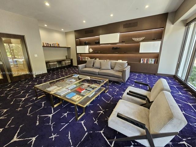 living room with recessed lighting, visible vents, and carpet floors
