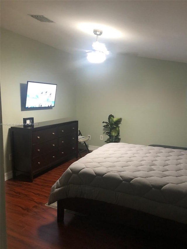 bedroom featuring baseboards, visible vents, and dark wood-style flooring