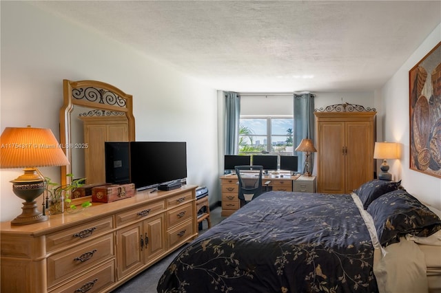 bedroom featuring carpet and a textured ceiling