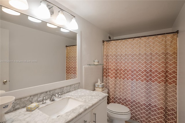 full bathroom with a shower with curtain, vanity, and toilet