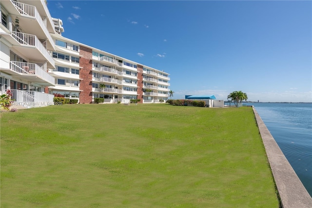 exterior space featuring a yard and a water view
