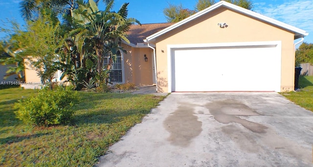 single story home with driveway, a front lawn, an attached garage, and stucco siding