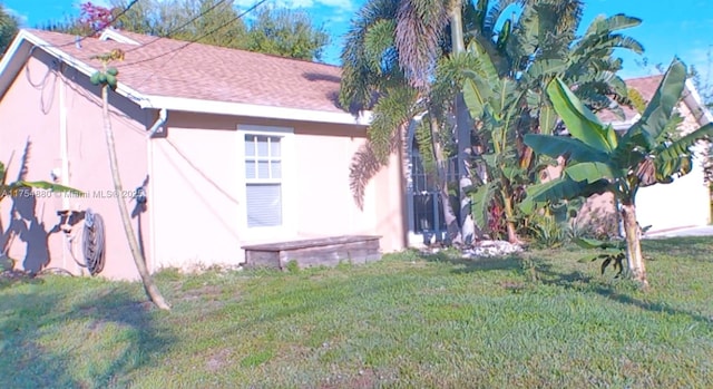 view of property exterior featuring a yard and stucco siding