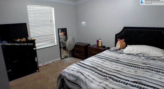 bedroom with light carpet and baseboards