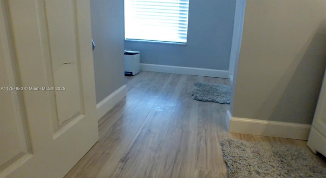 bathroom with baseboards and wood finished floors