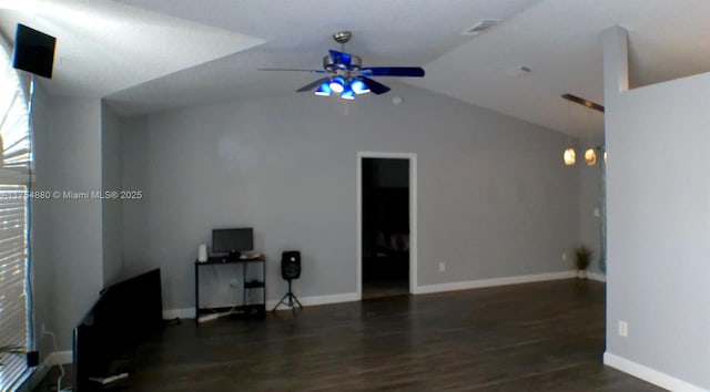 living room featuring lofted ceiling, wood finished floors, a ceiling fan, and baseboards