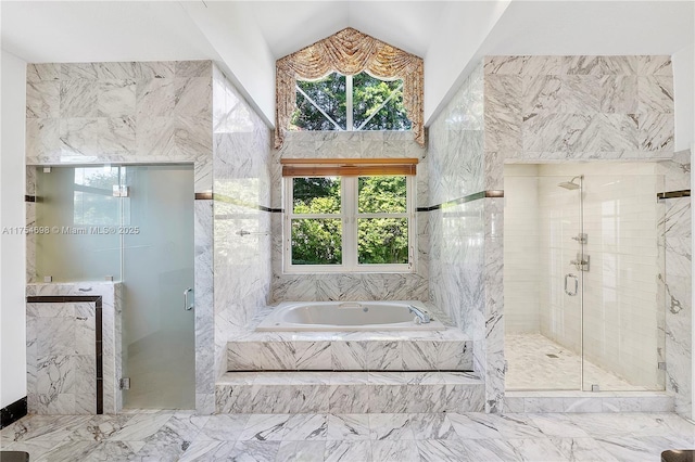 bathroom featuring vaulted ceiling, a shower stall, and a bath