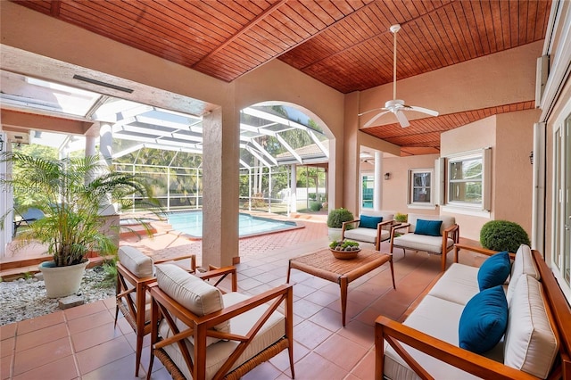 view of patio with an outdoor pool, a lanai, an outdoor hangout area, and a ceiling fan