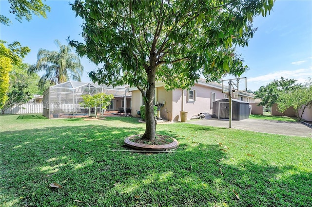 view of yard with a lanai, a patio area, and fence