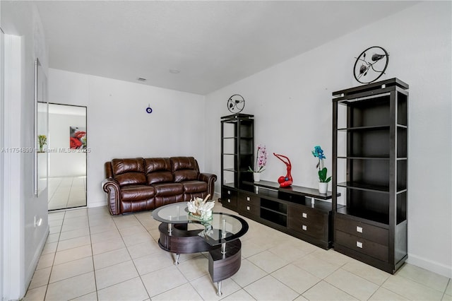 living room with baseboards and tile patterned floors