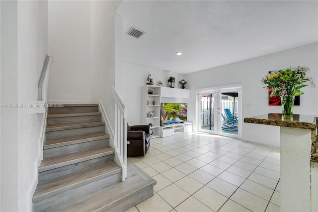 stairway featuring tile patterned flooring, french doors, visible vents, and recessed lighting