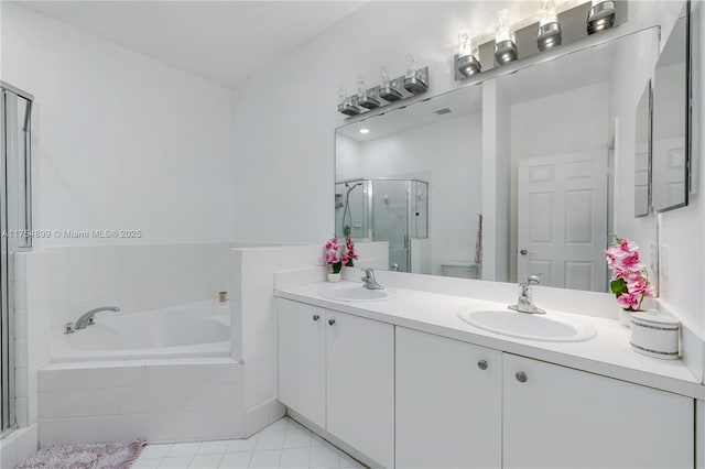 full bath featuring a sink, a shower stall, a bath, and double vanity