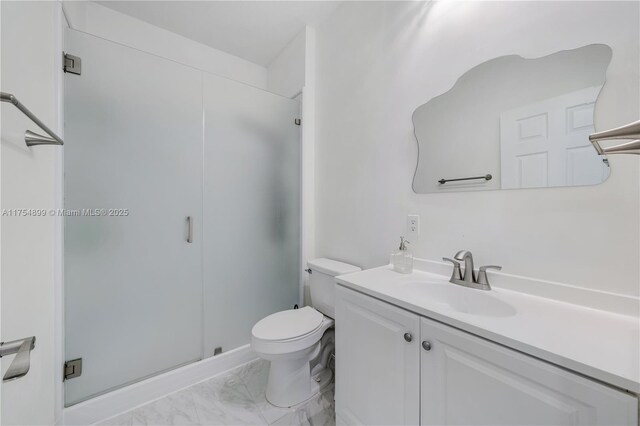 bathroom featuring marble finish floor, a shower stall, toilet, and vanity