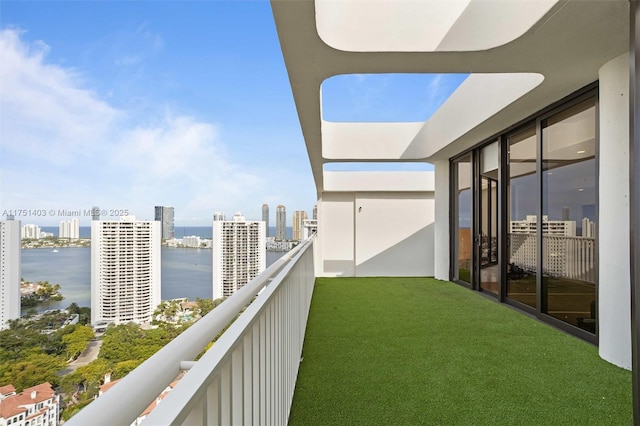 balcony with a water view and a city view