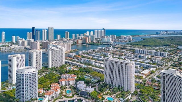 birds eye view of property featuring a water view and a city view