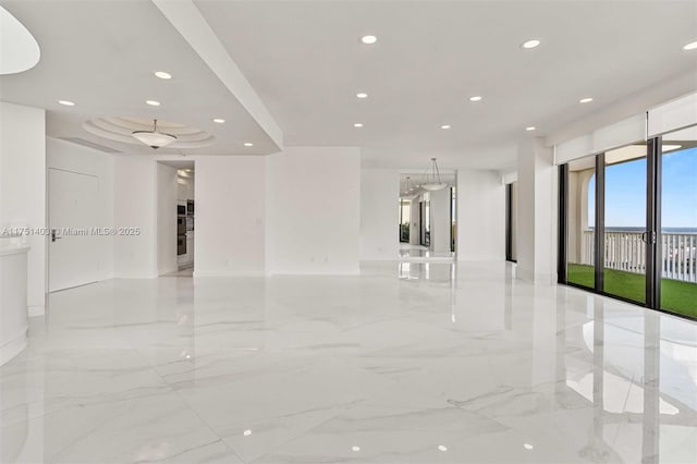 spare room featuring marble finish floor and recessed lighting