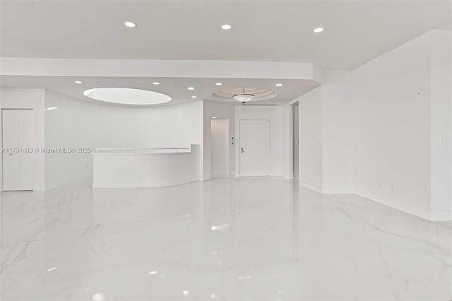 spare room featuring marble finish floor and recessed lighting