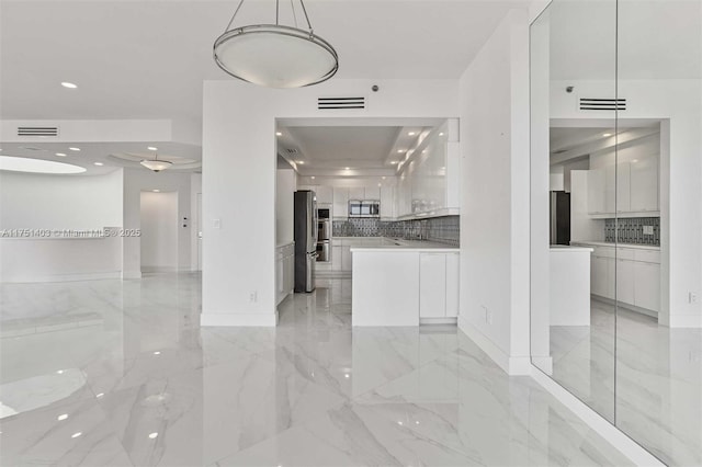 kitchen featuring white cabinets, marble finish floor, modern cabinets, and stainless steel appliances