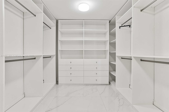 spacious closet featuring marble finish floor