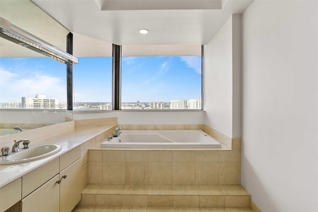 bathroom with a view of city, vanity, and a bath