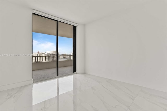 unfurnished room featuring marble finish floor and floor to ceiling windows