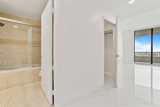 bathroom featuring toilet, recessed lighting, tiled shower / bath combo, baseboards, and marble finish floor